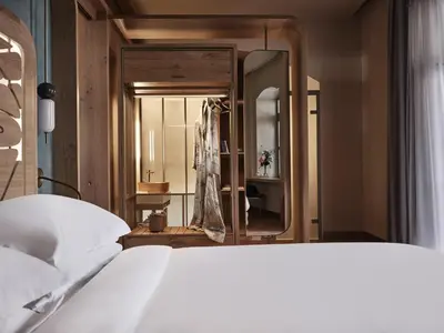 a bedroom with a bed and a large mirror at Domus Blanc Boutique Hotel in Chania Town