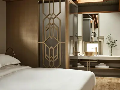a bedroom with a bed and a bathroom with a sink at Domus Blanc Boutique Hotel in Chania Town