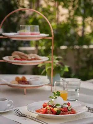 a white table with plates of food on it at Domus Blanc Boutique Hotel in Chania Town