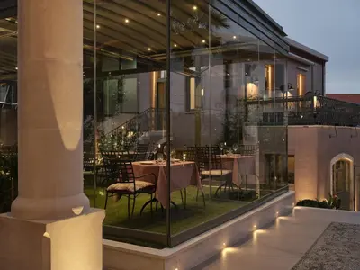 a restaurant with a table and chairs in a building at Domus Blanc Boutique Hotel in Chania Town
