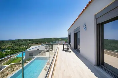 a balcony of a house with a swimming pool at Etheria Villa in Chania Town