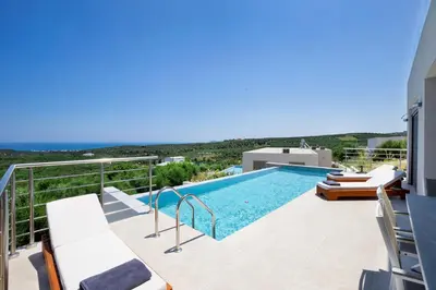 a villa with a swimming pool on the roof of a house at Etheria Villa in Chania Town