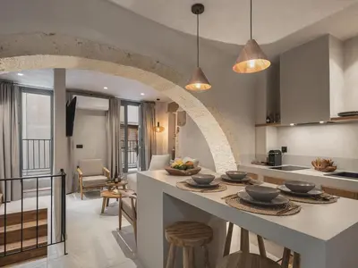a kitchen and living room with an archway at Casa Athanasia in Chania Town