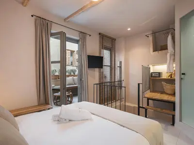 a bedroom with a white bed and a window at Casa Athanasia in Chania Town