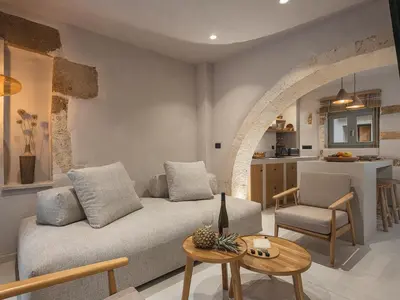 a living room with a couch and a kitchen at Casa Athanasia in Chania Town