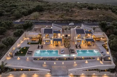 an aerial view of a house with two swimming pools at Melanthia Villas in Tsivarás