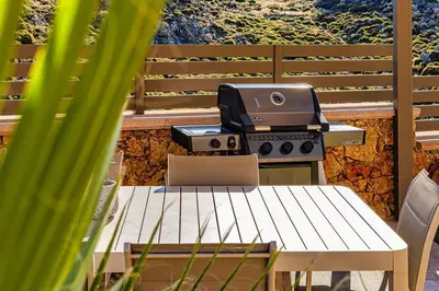 a grill sitting on top of a table on a patio at Apartment Lia with private eco pool - Amazing view in Chania Town