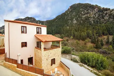 a building with a view of a mountain at Villa Zourva in Zoúrva