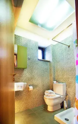 a bathroom with a toilet and a sink at Villa Zourva in Zoúrva