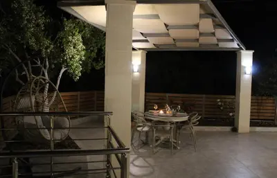 a table and chairs on a patio at night at Aryiro's Residence,Cozy&Sunny in Alikianós