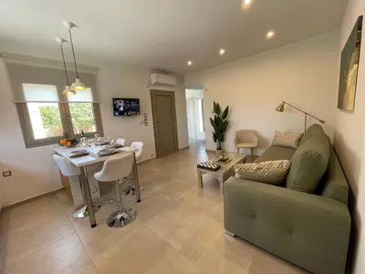 a living room with a couch and a table at Aryiro's Residence,Cozy&Sunny in Alikianós