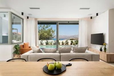 a living room with a couch and a table at 2 sea view Villas as 1 by Chania Living Stories in Chania Town
