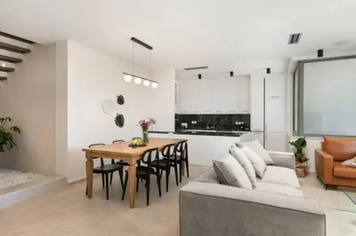 a kitchen and living room with a table and a couch at 2 sea view Villas as 1 by Chania Living Stories in Chania Town