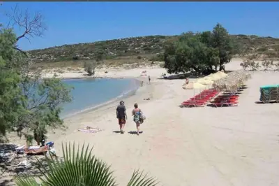 a man and a woman standing on a beach at 2 sea view Villas as 1 by Chania Living Stories in Chania Town