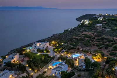 an aerial view of a villa at night at Seaview Villa Ormos, Heated Pool, Sea & Sun Villas in Chorafakia