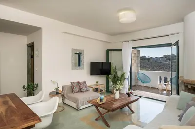 a living room with a couch and a table at Seafront Villa Shore, Sea & Sun Villas in Chorafakia