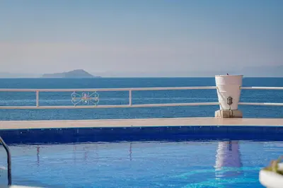 a swimming pool with the ocean in the background at Seafront Villa Shore, Sea & Sun Villas in Chorafakia