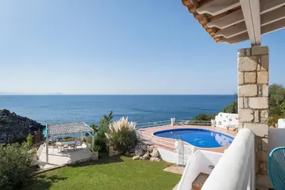 a villa with a swimming pool and a view of the ocean at Seafront Villa Shore, Sea & Sun Villas in Chorafakia