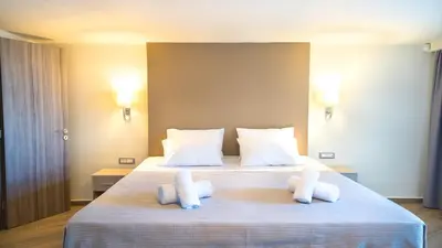 a bedroom with a large bed with two pillows at Golden View Luxury Villa Platanias in Plataniás