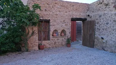 a building with two windows and potted plants in it at Golden View Luxury Villa Platanias in Plataniás