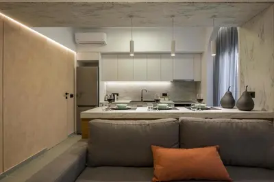 a living room with a couch and a kitchen at Amara Local Experience in Chania Town