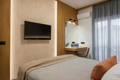 a hotel room with a bed and a desk at Amara Local Experience in Chania Town