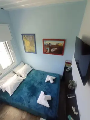a bedroom with a large blue bed with white pillows at Micro_Ble vacation home in Ropanianá