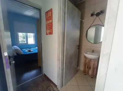 a bathroom with a sink and a mirror at Micro_Ble vacation home in Ropanianá