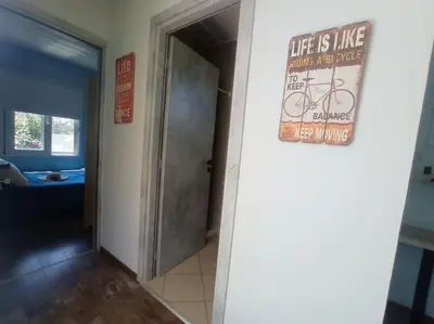 a hallway with alife is like a bike sign on a door at Micro_Ble vacation home in Ropanianá
