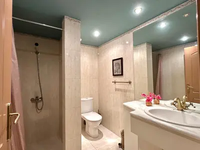 a bathroom with a toilet and a sink and a shower at Villa Kapodistria in Kallithea-Voukolies