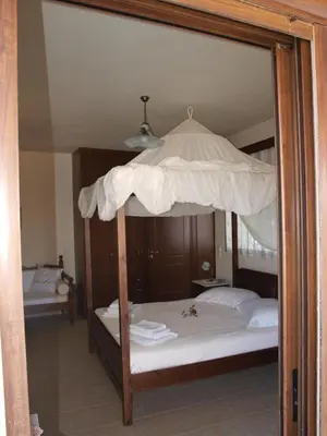 a bedroom with a bunk bed with a canopy at Villa Helidoni in Pondikianá