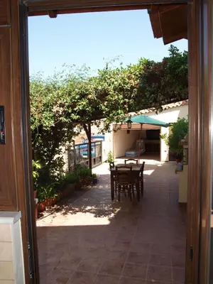 an open door to a patio with a table and chairs at Villa Helidoni in Pondikianá