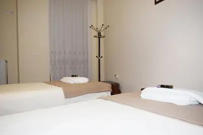 a room with two beds and a lamp in it at Villa Helidoni in Pondikianá