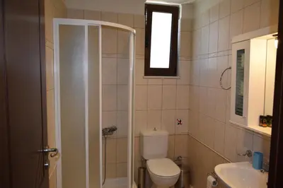 a bathroom with a toilet and a sink and a shower at Villa Helidoni in Pondikianá