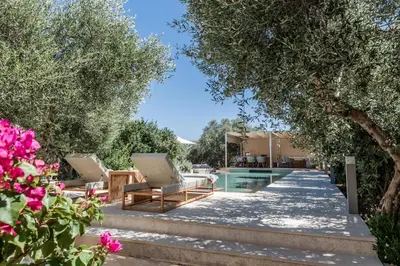 a villa with a pool and a yard at Villa Dimi in Kalathas
