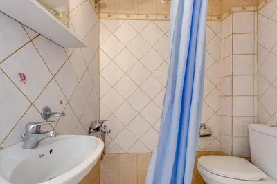 a bathroom with a sink and a toilet at IFIGENIA ROOMS BY MARIOS in Chania Town
