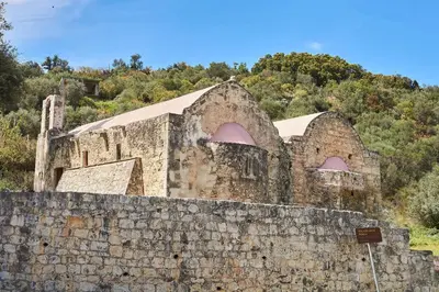 an old building behind a stone wall at La Maison to Chani in Stílos