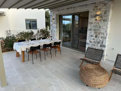 a dining table and chairs on a patio at Mitos Villas in Gerani Chanion