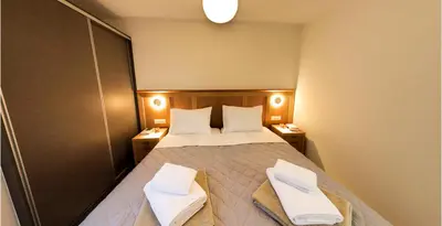 a bedroom with a bed with two towels on it at Mitos Villas in Gerani Chanion