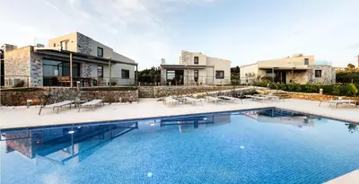 a large swimming pool in front of a house at Mitos Villas in Gerani Chanion