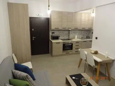 a kitchen with a table and a black door at ML in Chania Town