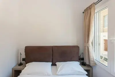 a bed with two pillows in a room with a window at ML in Chania Town