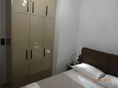 a bedroom with a bed and a white cabinet at ML in Chania Town