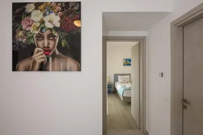 a room with a picture of a woman with flowers on the wall at Almyrida Hills Villas in Koprána