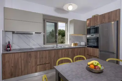 a kitchen with a bowl of fruit on a table at Almyrida Hills Villas in Koprána