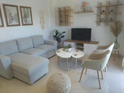 a living room with a couch and a table at Magedico 150m from the beach in Kissamos