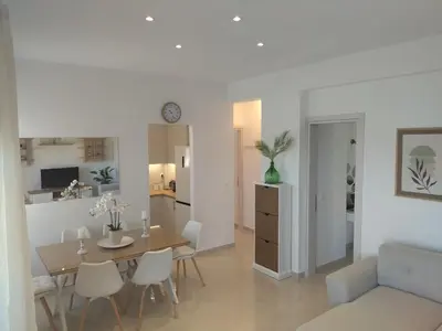a dining room and living room with a table and chairs at Magedico 150m from the beach in Kissamos