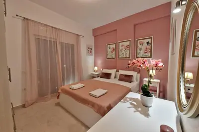 a bedroom with a large bed and a mirror at Magedico 150m from the beach in Kissamos