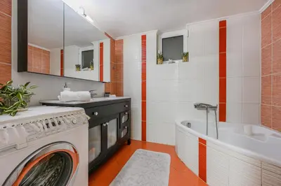 a bathroom with a washing machine and a tub at Seafalios Villa in Chania Town