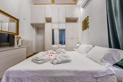 a bedroom with a white bed with towels on it at Seafalios Villa in Chania Town